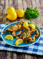 Image of crispy fried soft shell crabs served with fresh lemon on blue plate printed on Printed Glass Basin Splashbacks
