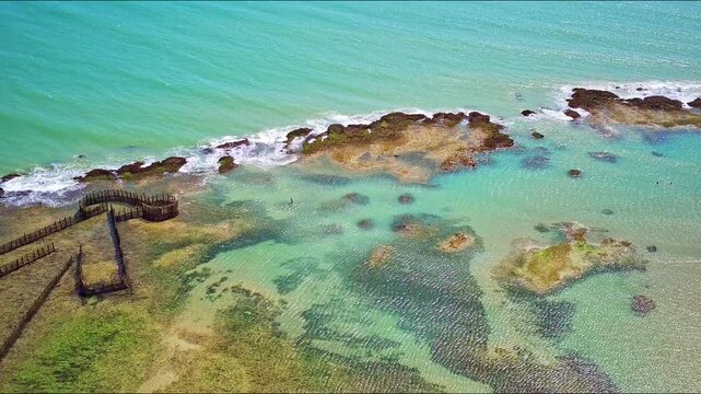 Aerial view of Paracuru beach with reefs on the sea. Ceara, Brazil.