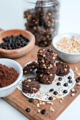 tasty vegan chocolate oats cookies with peanut butter on wooden background recipe or cook book photo. Homemade chocolate biscotti cookies with walnuts.