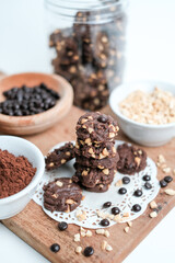 tasty vegan chocolate oats cookies with peanut butter on wooden background recipe or cook book photo. Homemade chocolate biscotti cookies with walnuts.