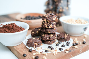 tasty vegan chocolate oats cookies with peanut butter on wooden background recipe or cook book photo. Homemade chocolate biscotti cookies with walnuts.