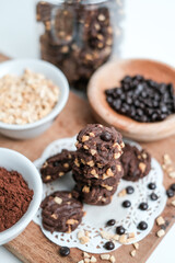tasty vegan chocolate oats cookies with peanut butter on wooden background recipe or cook book photo. Homemade chocolate biscotti cookies with walnuts.