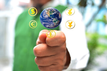 Dollar, euro, pound sterling, yen and yuan currency symbols on earth and hand background.