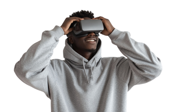 Smiling young man in a gray hoodie adjusting his VR headset with a confident expression. The soft white background enhances the modern and tech-focused vibe.

