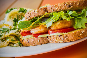 sautéed shrimp sandwich with mixed greens, tomato, and a spicy aioli