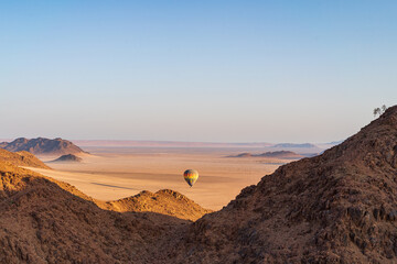 Hot Air ballooning over the Namib Desert in Namibia at dawn in a colourful hot air balloon