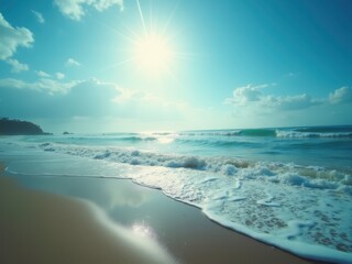 A serene beach scene with gentle waves rolling onto the shore under a bright sun. The sky is clear with a few scattered clouds, creating a peaceful atmosphere
