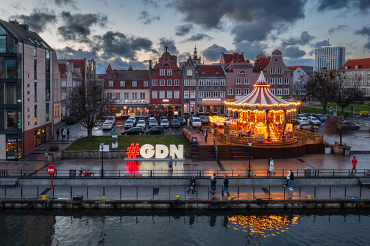 Gdansk, Poland - January 2, 2025: Gdansk carousel over the Motlawa river at winter duskt, Poland
