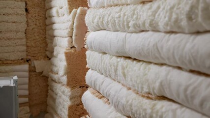 Close up view reveals layers of various insulation materials, highlighting construction techniques for energy efficiency and thermal performance in buildings