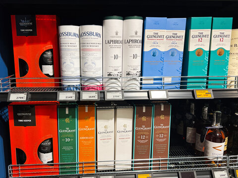 Kyiv, Ukraine - January 11, 2025: Shelf of diverse selection of Scottish whisky bottles in a liquor store