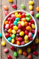 Obraz premium Colorful candies in a white bowl on a rustic wooden surface.