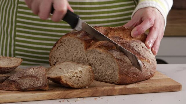 slicing sourdough bread by knife food