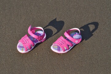 Kids sandals on a beach 