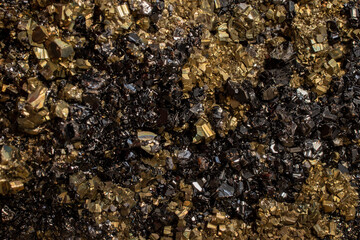 Pyrite mineral flower black and golden color soft focus close up, abstract pattern structure