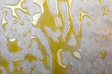 Extra virgin olive oil spread on a gray baking paper background, culinary minimal backdrop