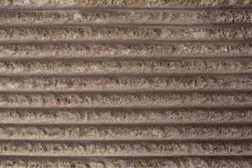 Velvet corduroy upholstery with thick fibers, brown color horizontal  lines backdrop, abstract texture close up