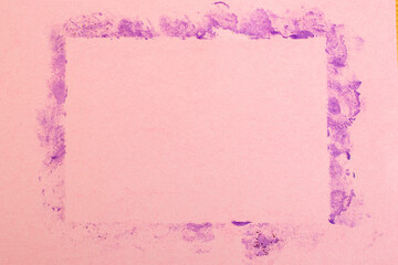 Purple makeup  finger print smudges in rectangular shape frame on pink background, abstract...