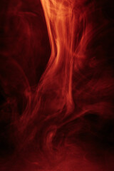 Abstract red and black smoky texture resembling fire or fog, with dramatic swirling patterns creating a sense of heat, mystery, and intensity.