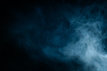 Abstract swirling blue smoke on a dark background, creating a mysterious and ethereal atmosphere. Perfect for artistic, moody, or creative designs.