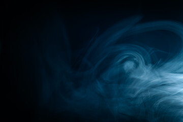 Abstract swirling blue smoke on a dark background, creating a mysterious and ethereal atmosphere. Perfect for artistic, moody, or creative designs.