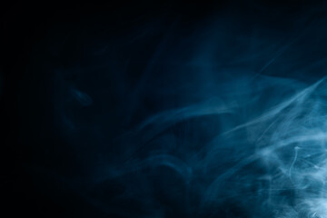 Abstract swirling blue smoke on a dark background, creating a mysterious and ethereal atmosphere. Perfect for artistic, moody, or creative designs.