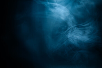 Abstract swirling blue smoke on a dark background, creating a mysterious and ethereal atmosphere. Perfect for artistic, moody, or creative designs.