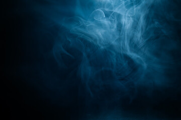Abstract swirling blue smoke on a dark background, creating a mysterious and ethereal atmosphere. Perfect for artistic, moody, or creative designs.