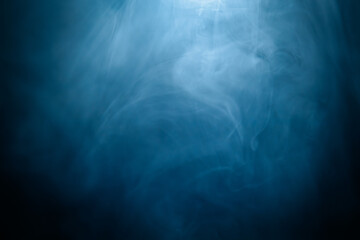 Abstract swirling blue smoke on a dark background, creating a mysterious and ethereal atmosphere. Perfect for artistic, moody, or creative designs.