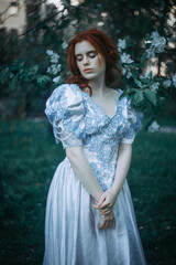 fine art portrait of redhead woman in historical vintage dress