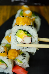 Delicious sushi grabbed with chopsticks