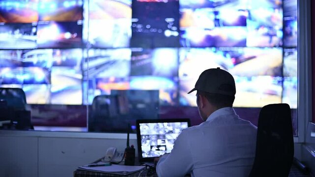 Security guards are monitoring multiple CCTV monitors and reporting on events that occur.
