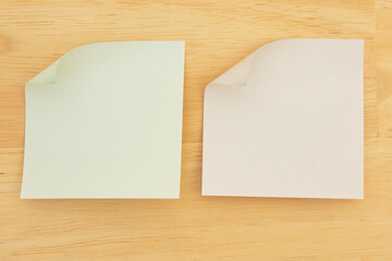Two Sticky Notes on Wood Desk