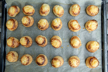 Pogaca stuffed with cheese. A full tray of fresh Pogaca traditional Eastern European salty buns with cheese - Pogace.