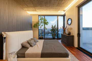 The modern bedroom boasts a stunning view and an elegant, minimalist design that captivates all