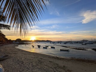 Sunset at Praia dos Ossos in Buzios with the sea and boats in the background