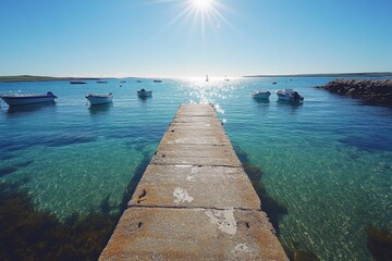 Fototapeta premium Pier extending into crystal clear turquoise water under a bright sky
