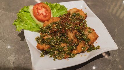 Crispy fried fish with spicy green chili sauce.