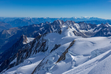 Obraz premium Snow mountain summits and white ice glacier in the Alps. Mont Blanc climbing route and views from ascent on Montblanc. Classic Gouter route to the highest mountain in Europe, France