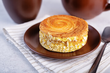 Croissant roll with mango in a plate on a white  background