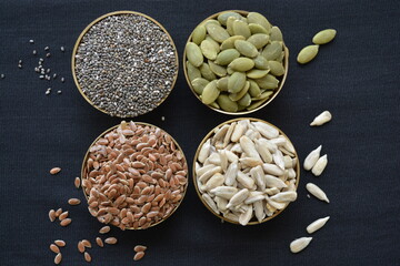 seeds rich in unsaturated fatty acids in brass bowls

