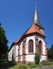 Medieval church with bell tower and gothic apse in the old village of Freckenfeld, Rheinland-Pfalz region in Germany