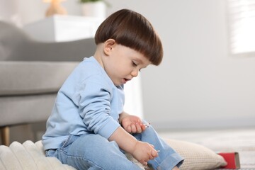 Little boy playing with matches at home. Child in danger