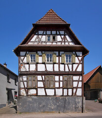 A decaying half-timbered wooden residential house with its half-hipped gable in the old village of Schaidt, Pfalz region in Germany