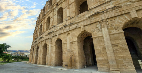 Amphitheater of El Jem in Tunisia with blue sky and clouds..