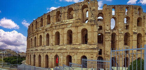 Amphitheater of El Jem in Tunisia with blue sky and clouds..
