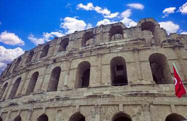 Amphitheater of El Jem in Tunisia with blue sky and clouds..