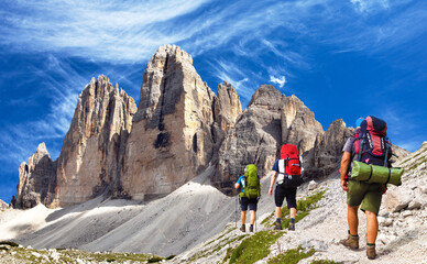 three hikers and Drei Zinnen or Tre Cime di Lavaredo