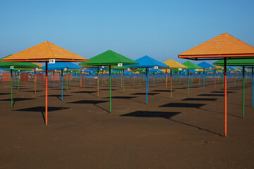 umbrellas on the beach, multi-colored beach umbrellas on the Caspian sea