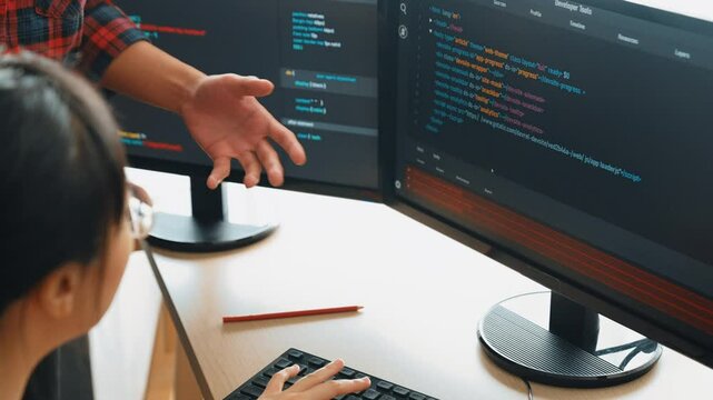 Slow motion back end or software developer manager supervising his team on new application program development on debugging and solving complex code algorithms on monitor. Burgeoning