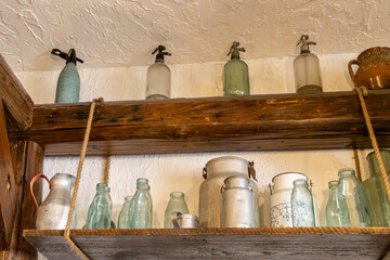 Old glass bottles on a shelf. Retro antique syphon bottles